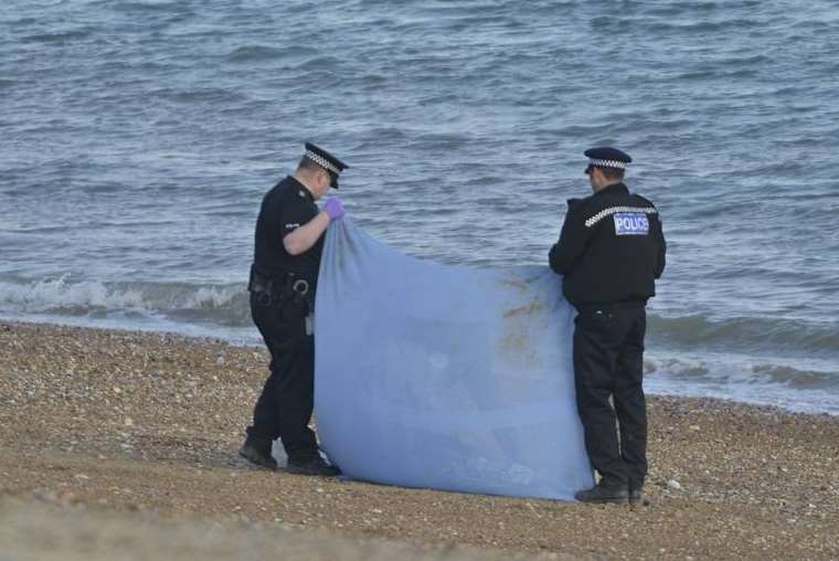 Police at the spot where a body washed up on the beach at Hythe. Picture: Gary Browne
