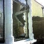 Burglar is left wedged in window.