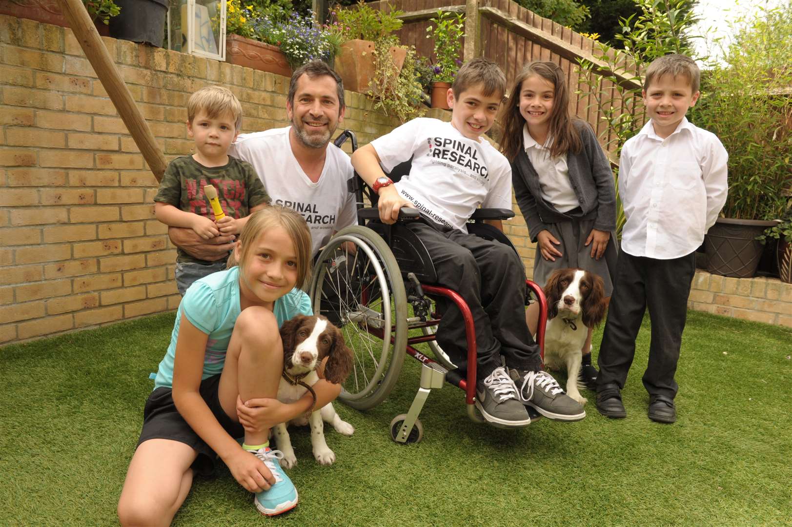 The Rafferty family in 2014, from left, George, then two, dad Adrian, Jake Rafferty, then 11, Lizzie then seven,Oliver then five and Jess, then aged nine, with dogs Dicey, left, and Finlay. Picture: Steve Crispe