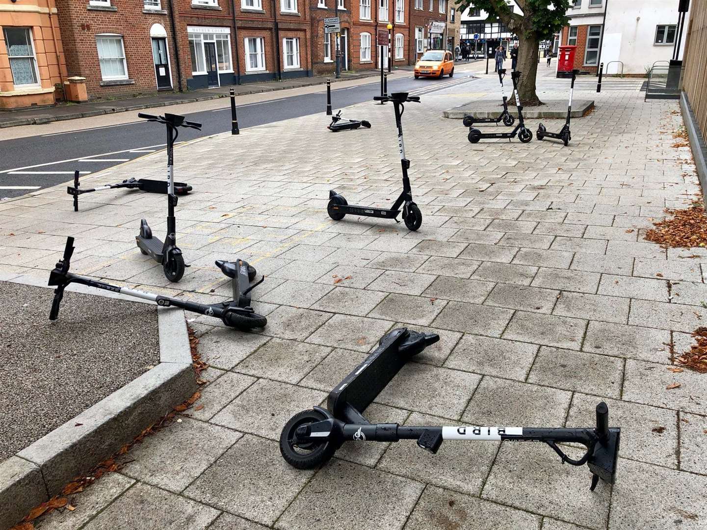 A number of Bird e-scooters have been left strewn across Station Road West, Canterbury. Picture: Sian Pettman