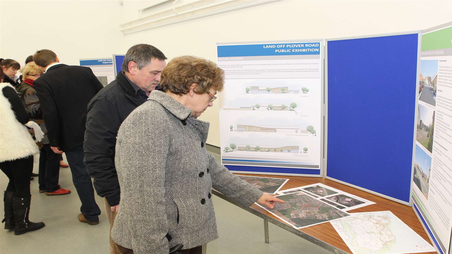 Members of the public view boards showing details of the project