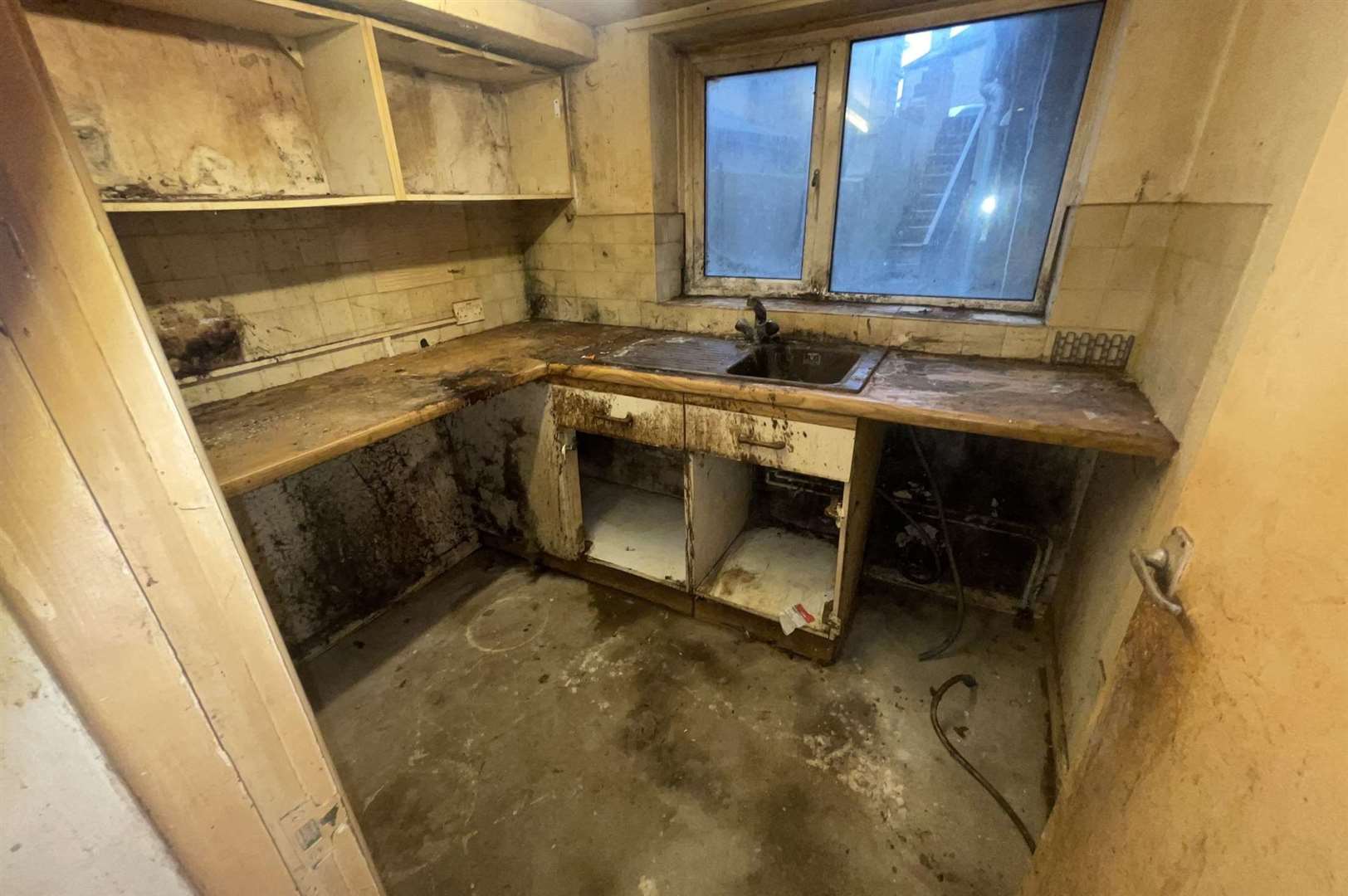 The kitchen floors, surfaces and sink were caked in grime and dirt. Photo: SWNS