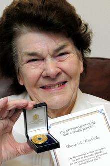Doris Nicholls with her medal to commemorate her services at Bletchley Park