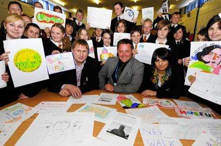 Students show their designs to, seated from left, James Blake, headteacher Julian Barritt and Noor Itrakjy