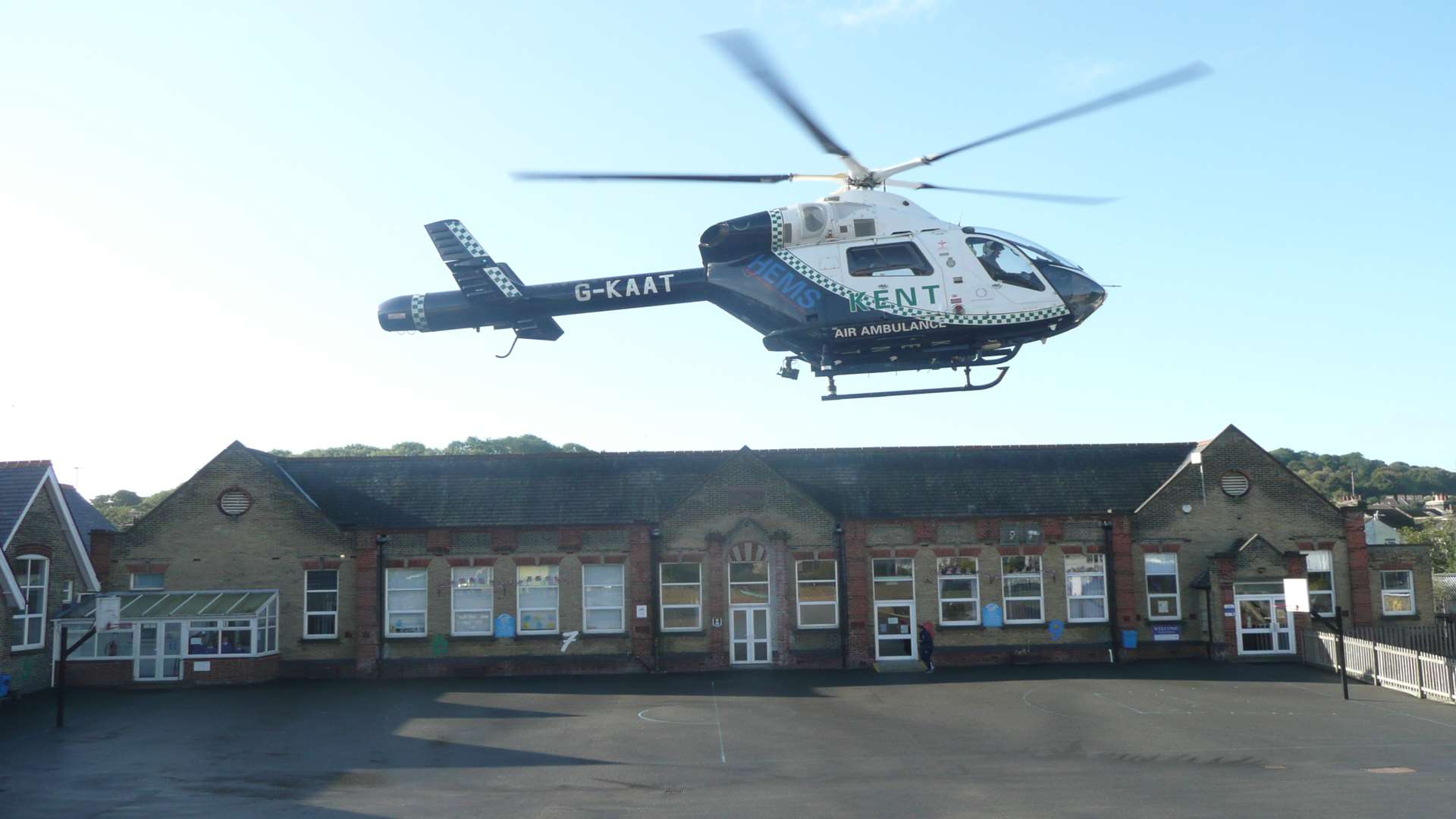 An air ambulance takes off from Barton Junior School