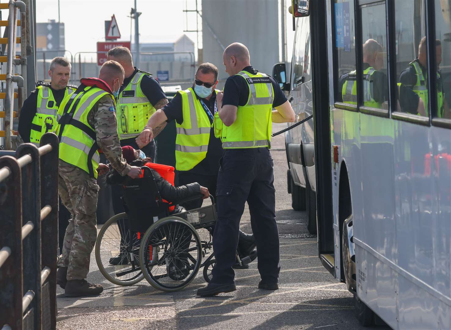 The Royal Navy officers helping a woman in a wheelchair off the boat in Dover. Picture: UKNIP