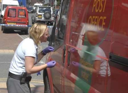 The cash-in-transit van being examined for clues at the scene of the robbery. Picture: GRANT FALVEY