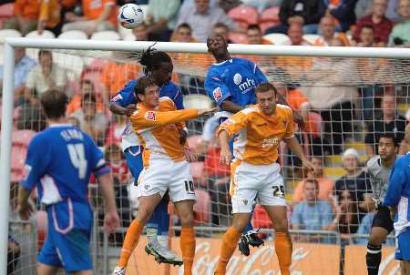 Gillingham defenders Grent Sancho and Ian Cox combine to keep Blackpool at bay at Bloomfield Road on Saturday. Picture: PHILL HAYWOOD