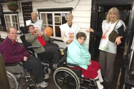 NOT EASY: Wheelchair-bound Dean, Trev and Barbara, volunteers Jackie Cloude and Jean Chauvin, and support manager Carolyn Robinson demonstrate the narrow doors at the Railway Tavern. Picture: ANDY PAYTON