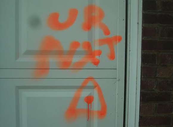 The spray painted message on the door