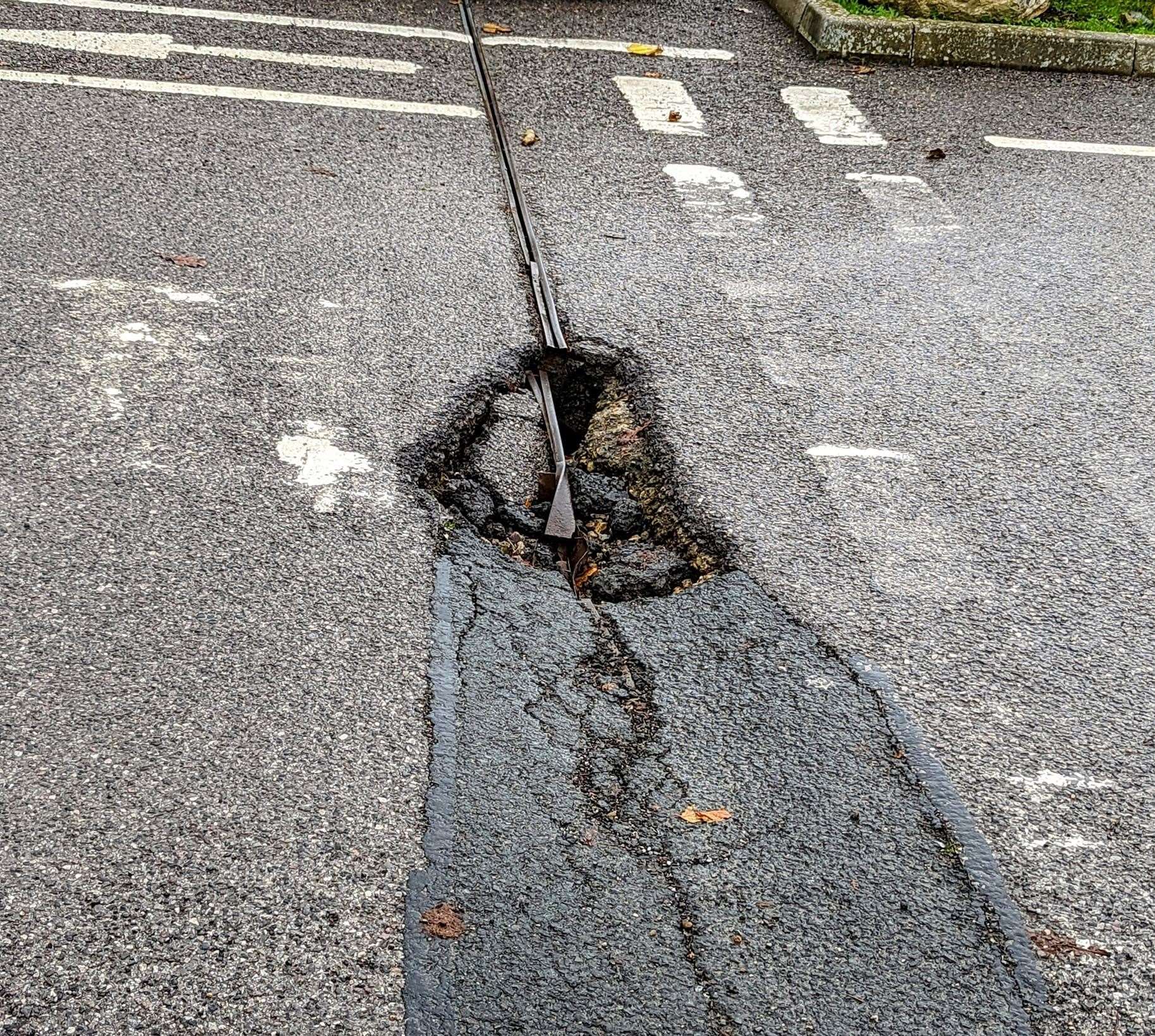 The pothole has opened up at the retail park's exit point