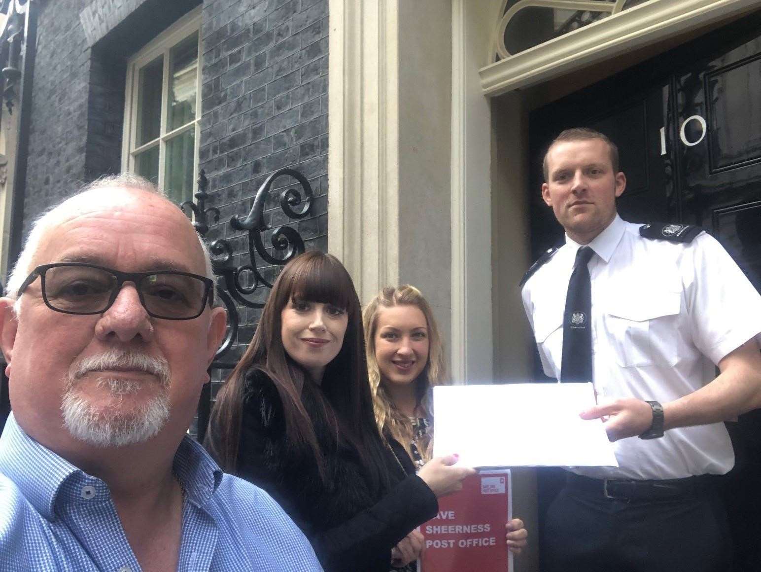 Mole Meade, of the Communications Workers Union, and Laura Steele and Stephanie Nicholls, who work in the Sheerness Post Office, handing over the petition to Number 10