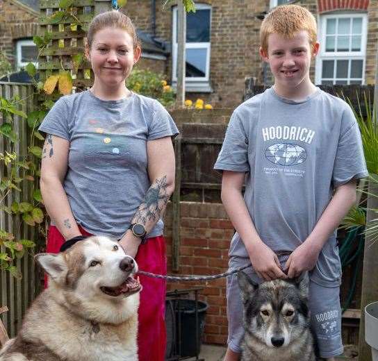 Nick Bradfield - who saved his sister and dog from a fire - with his mum Louise with their two dogs. Picture: KFRS