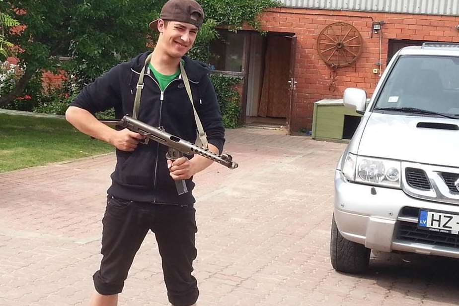 Robert Kokins poses with a gun on Facebook
