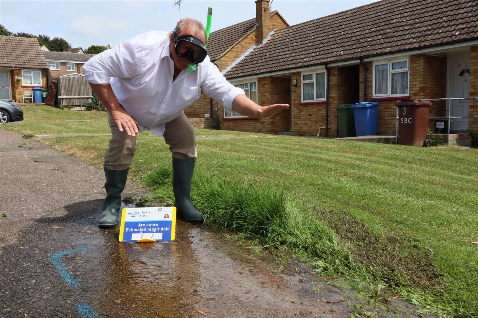 Sheppey businessman Sean D'Alton dons snorkel and goggles to check out the water leak in Petfield Close, Minster