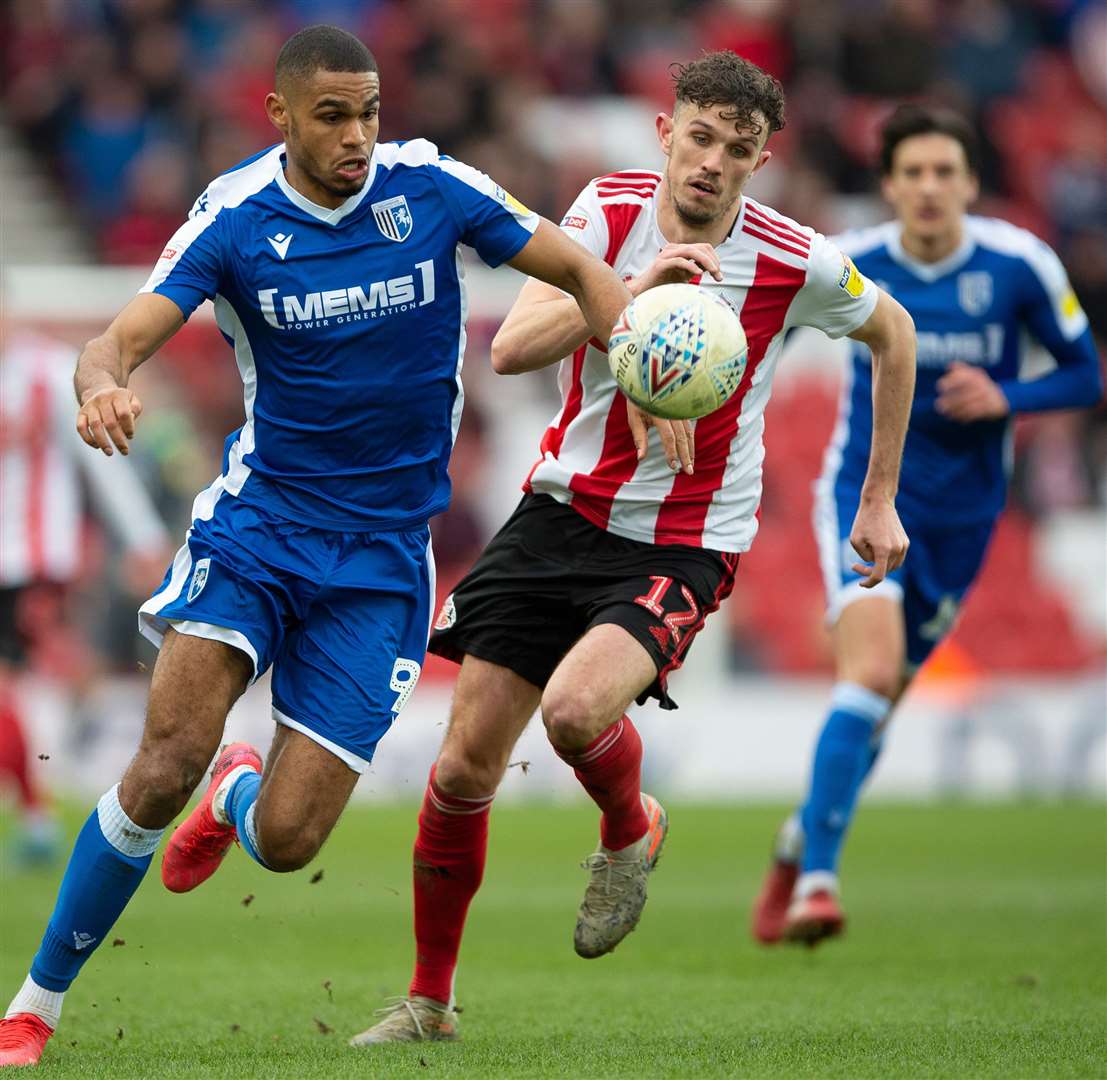 Gillingham striker Mikael Mandron gets away from Tom Flanagan Picture: Ady Kerry