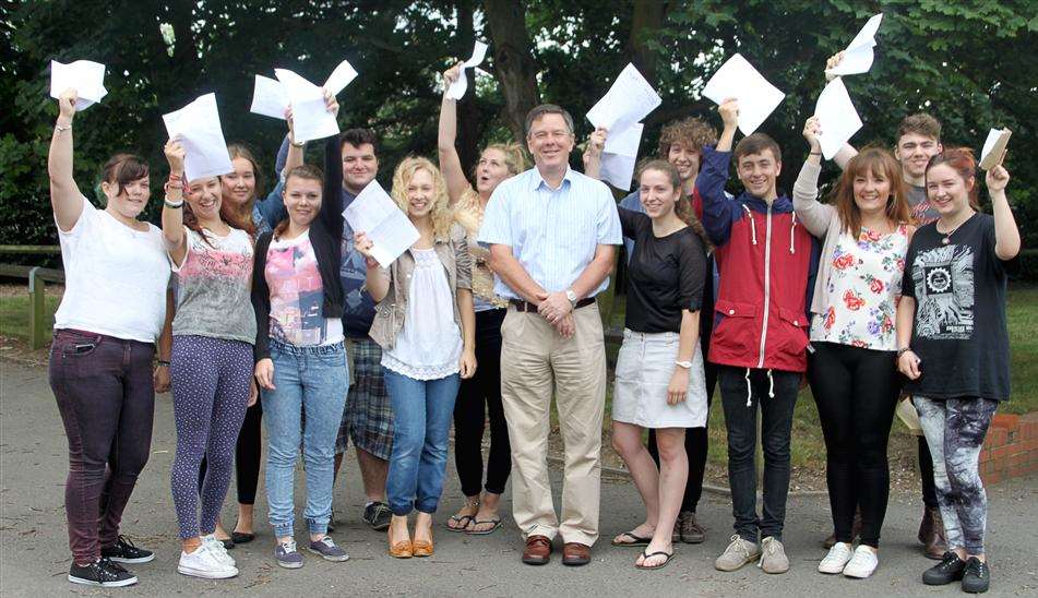 Students at Fulston Manor School celebrate their A-level results. Head teacher Alan Brookes is pictured centre.
