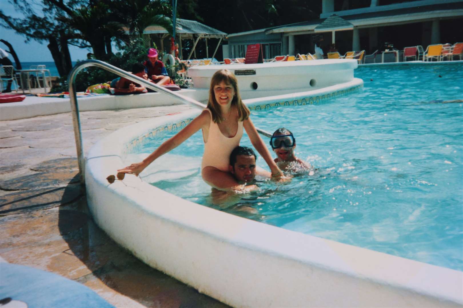 Honeymoon in Barbados July 1993. Nicky Clifford who couldn't go in the water because she was having dialysis gets a piggyback from her husband