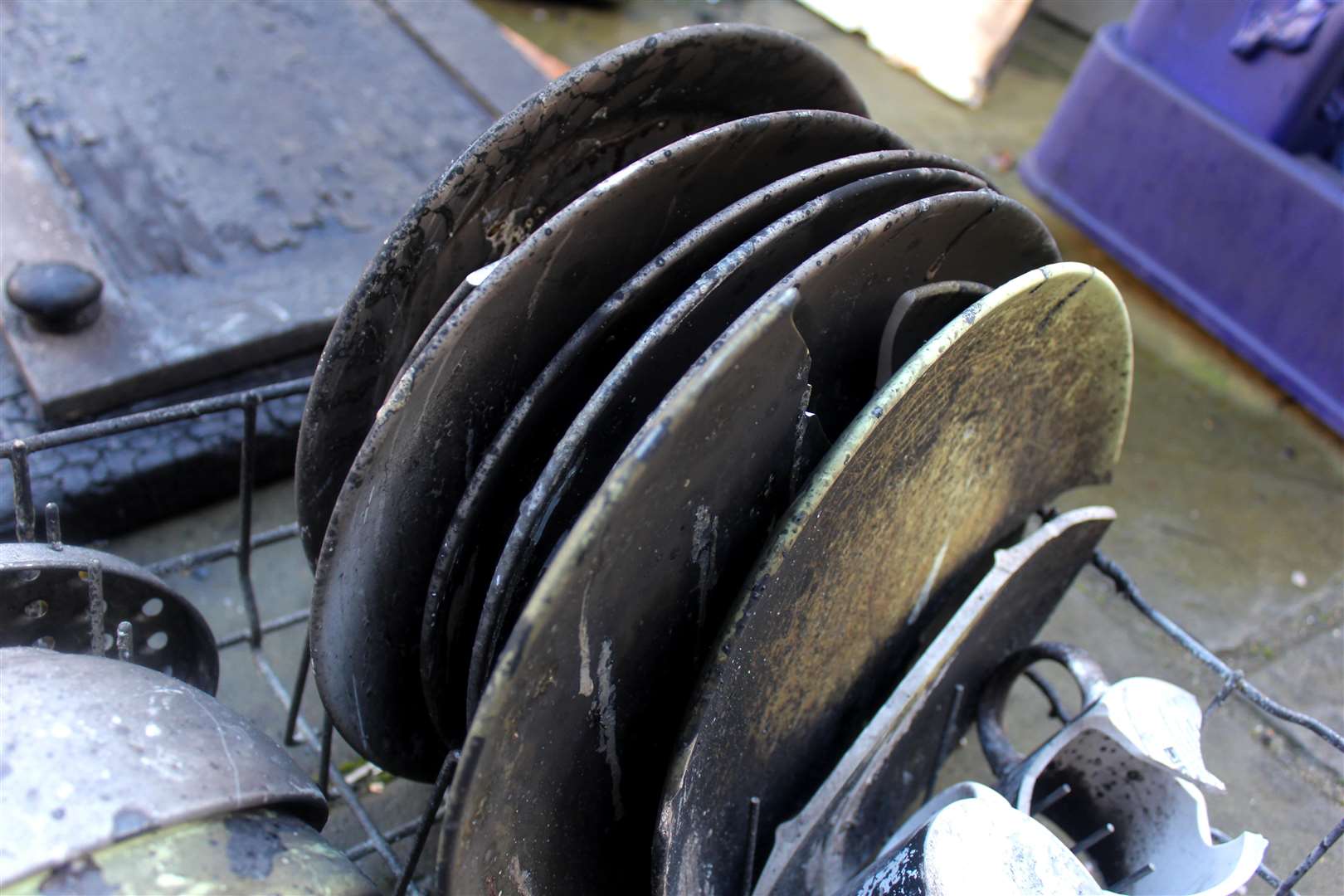 Damaged plates after a dishwasher fire. Stock photo.