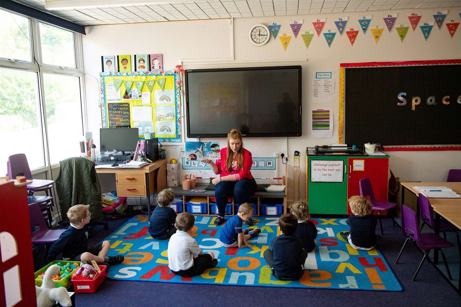 Children of essential workers socially distance whilst in lessons (Jacob King/PA)