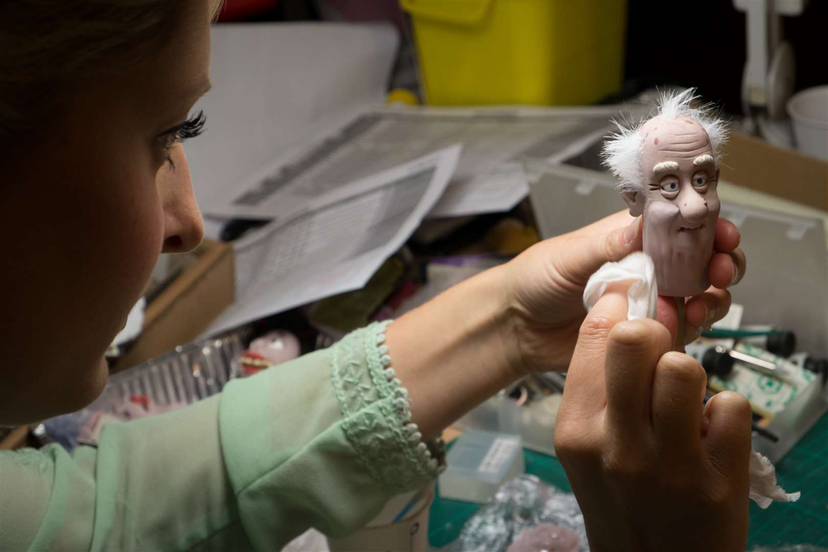Emma blends the mouth of an old man puppet while working on Shaun the Sheep the Movie