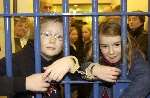 BEHIND BARS: Two of the visitors to the open day Harry and Mimi Davies. Picture: ANDREW WARDLEY