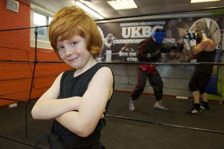 Ethan Owers, seven, has gained a black belt in kickboxing