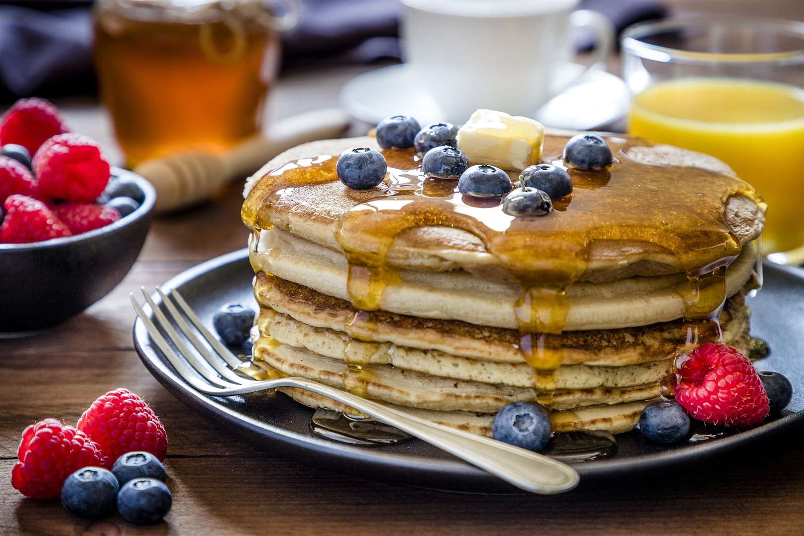 Stacks of pancakes topped with blueberries and syrup. Picture: Getty