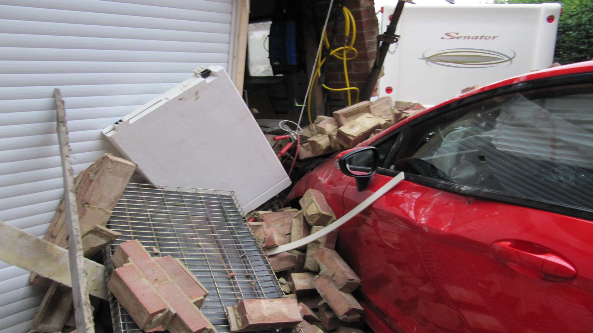 The car smashed into the side of the garage.