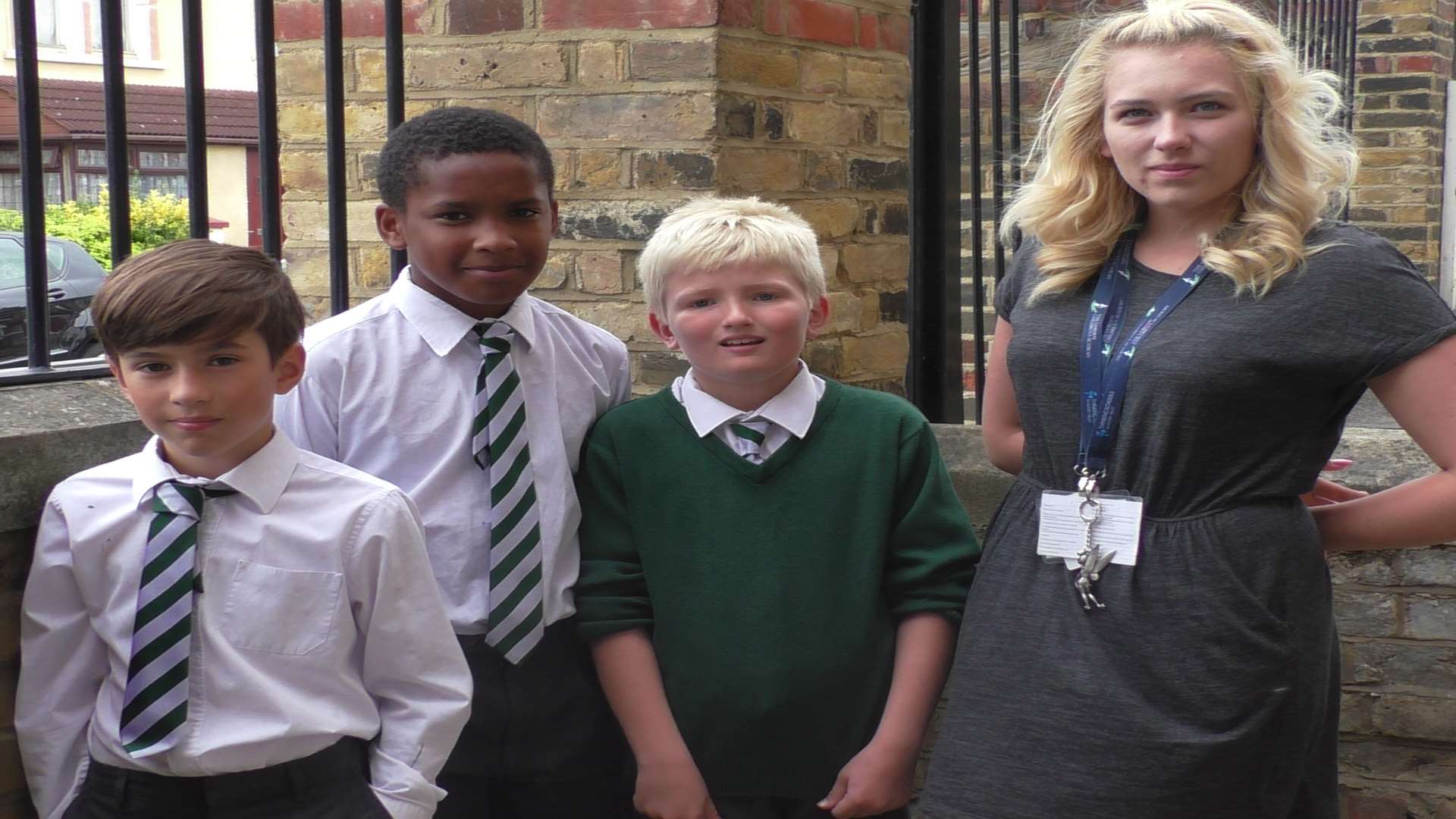 Oscar, nine, Kamarl and Max, both 10, and teaching assistant Jessica Yelton, who has re-homed the kitten