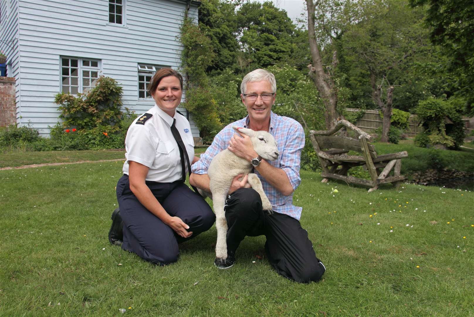 Animal lover Paul O'Grady and RSPCA Inspector Caroline Hall with Winston the lamb. Picture RSPCA