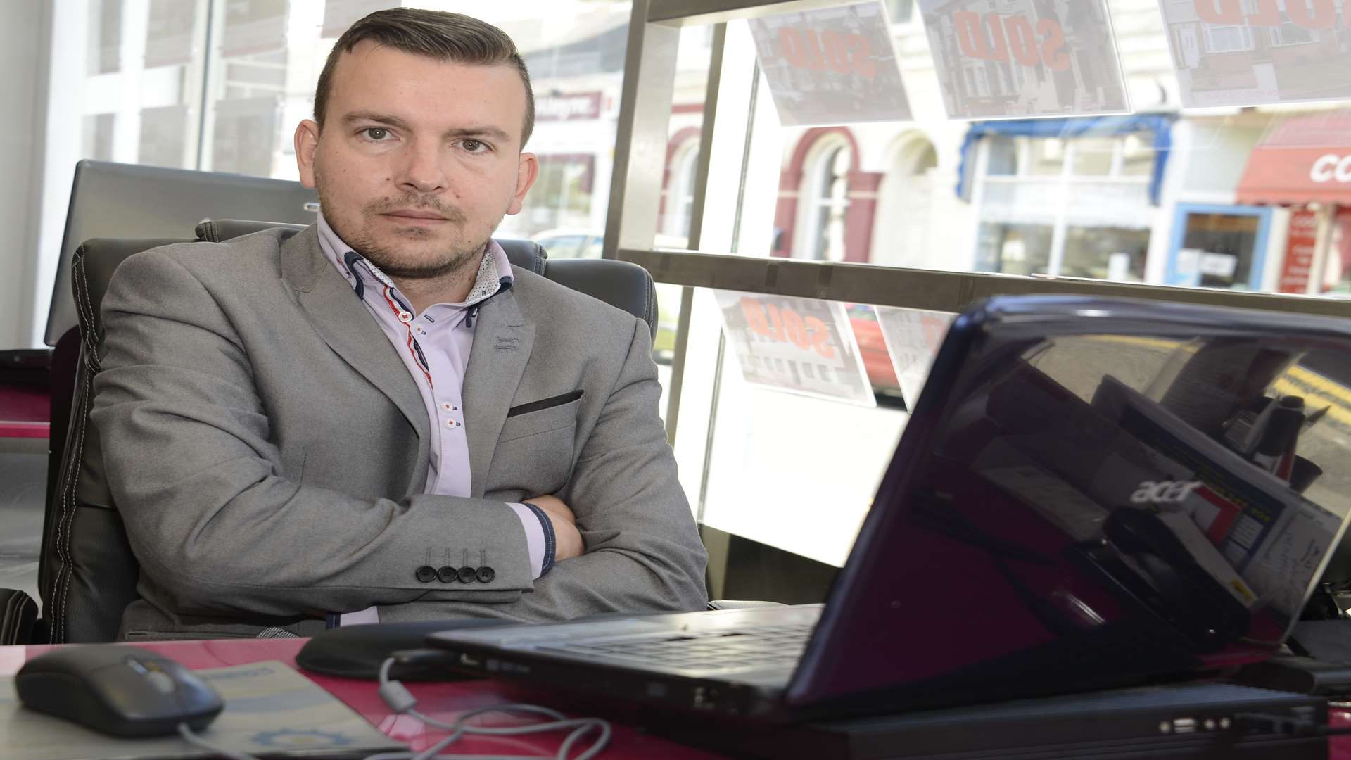 Estate agent Daniel Wells at the desk where he was attacked by Fergus Wilson