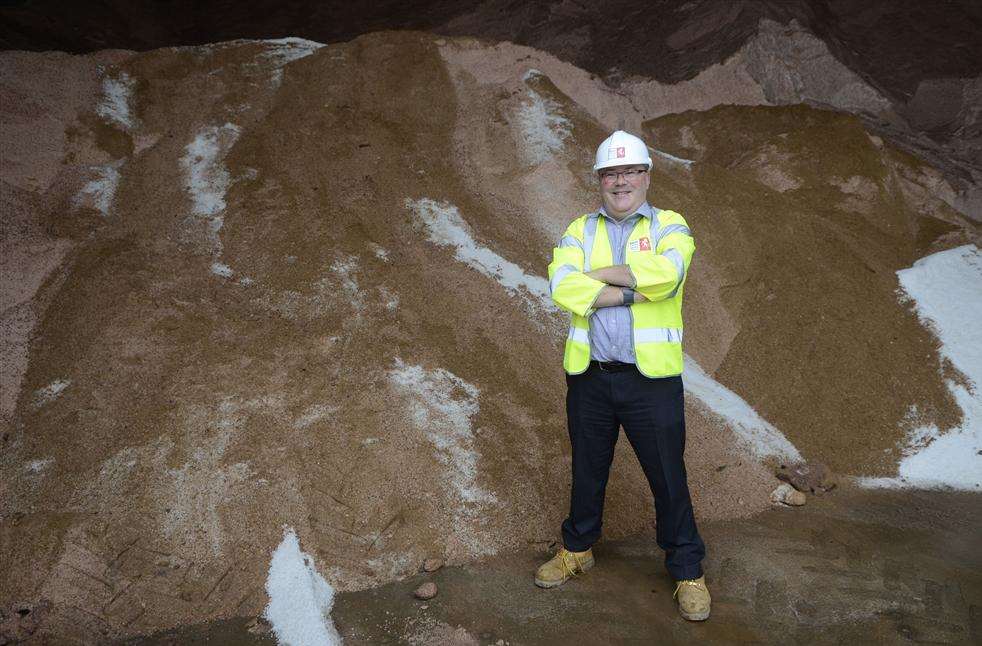 Toby Howe, Highways Manager for East Kent in front of winter salt stocks at KCC's Ashford depot