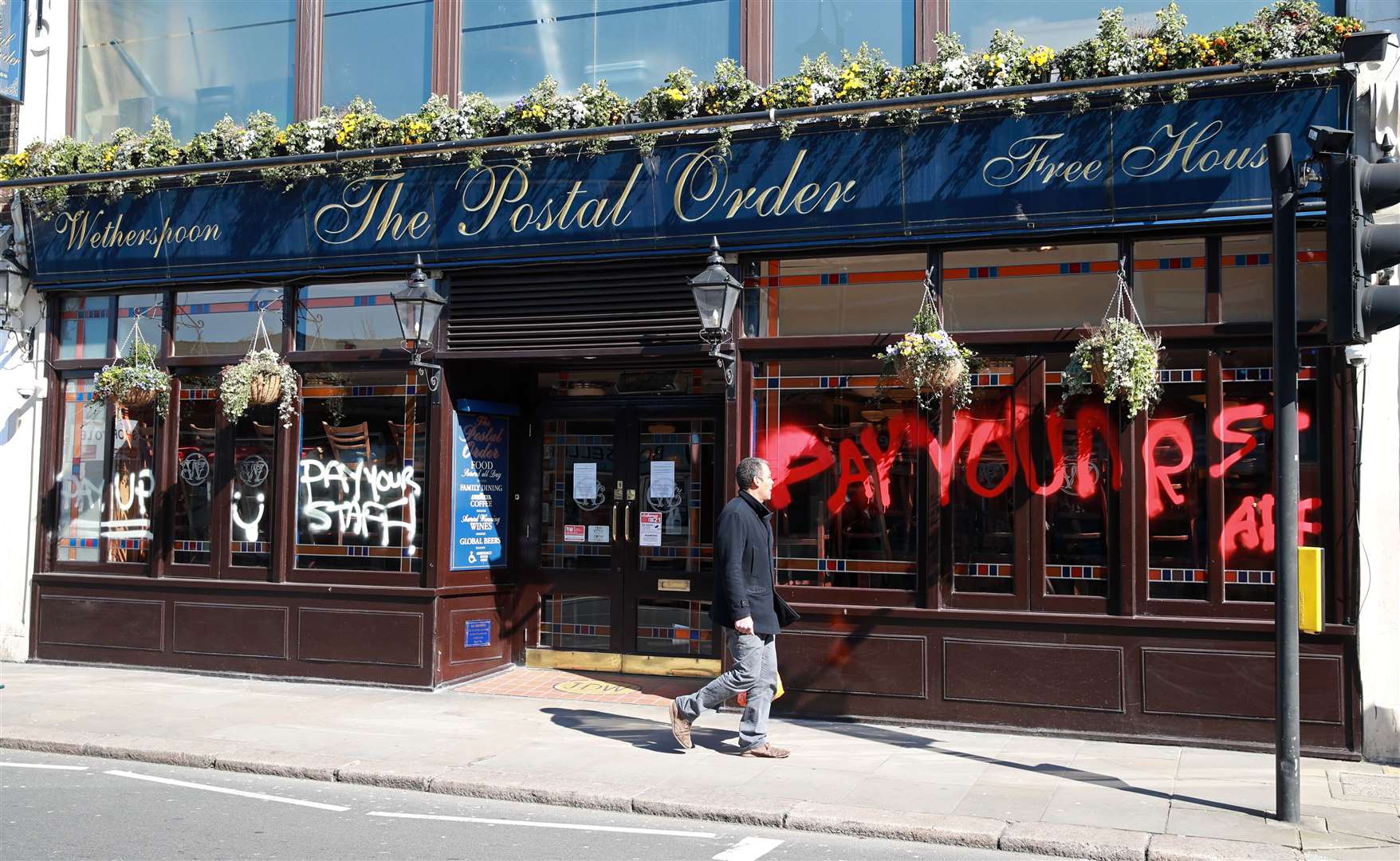 A Wetherspoon’s pub was sprayed with graffiti after founder Tim Martin said staff may not get paid (Adam Davy/PA)
