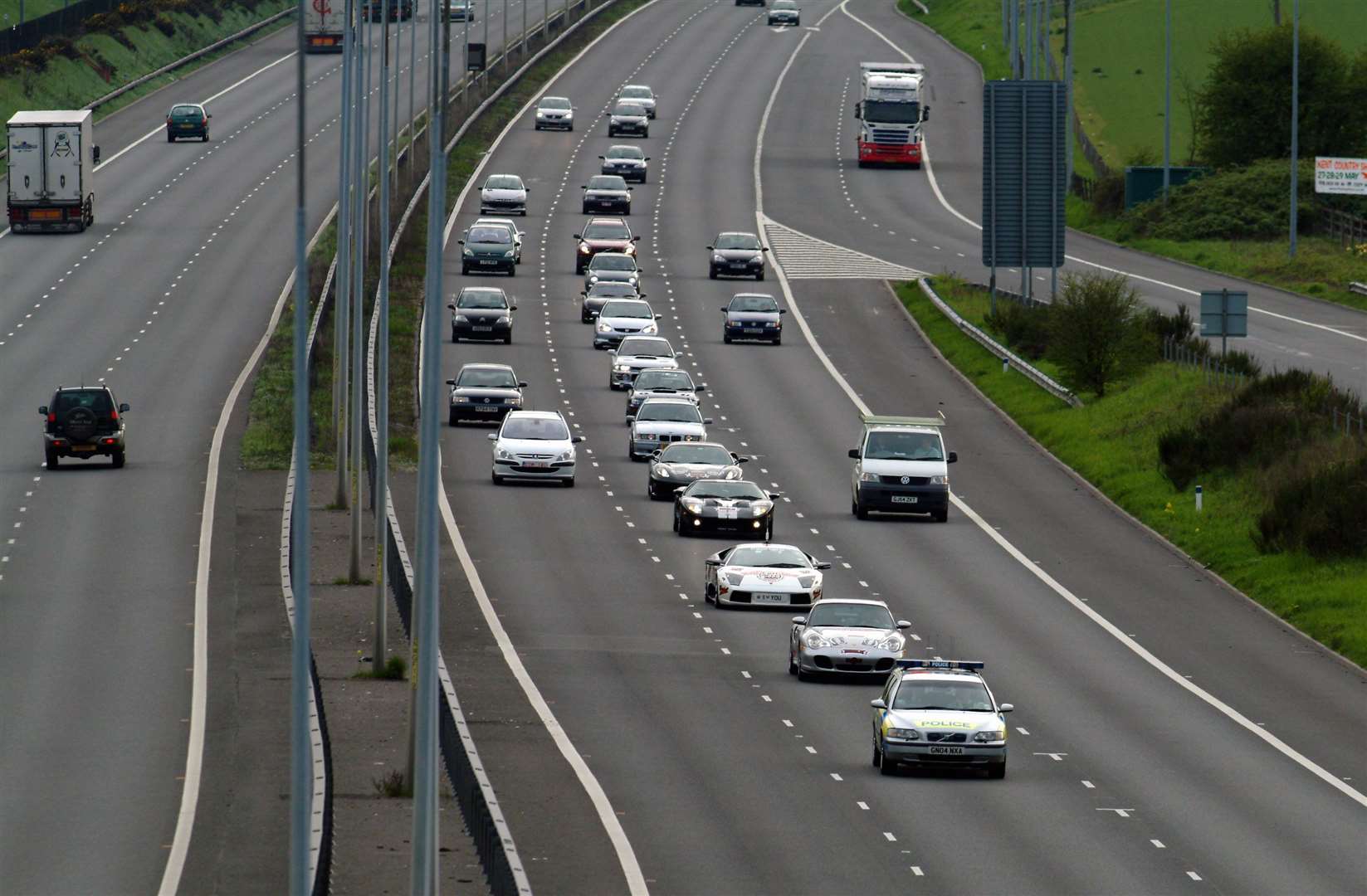 Police keep an eye on the Gumball Rally entrants on the M20 in 2006