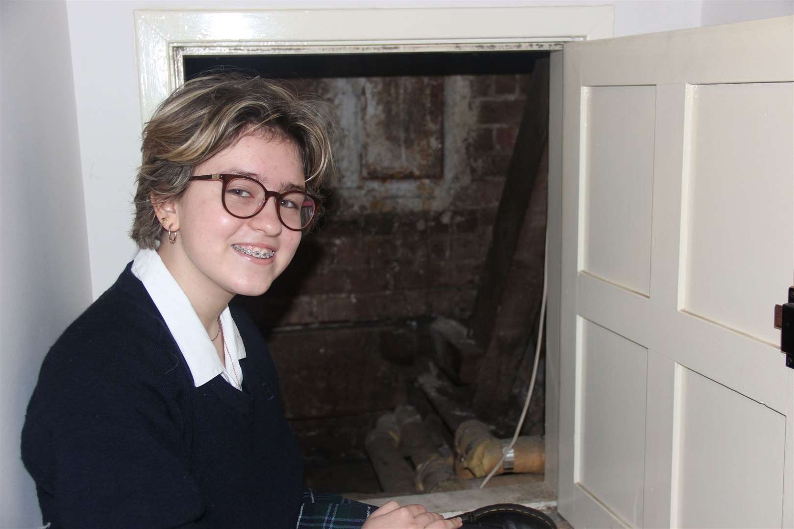 Hailey McNally with the hidden cupboard