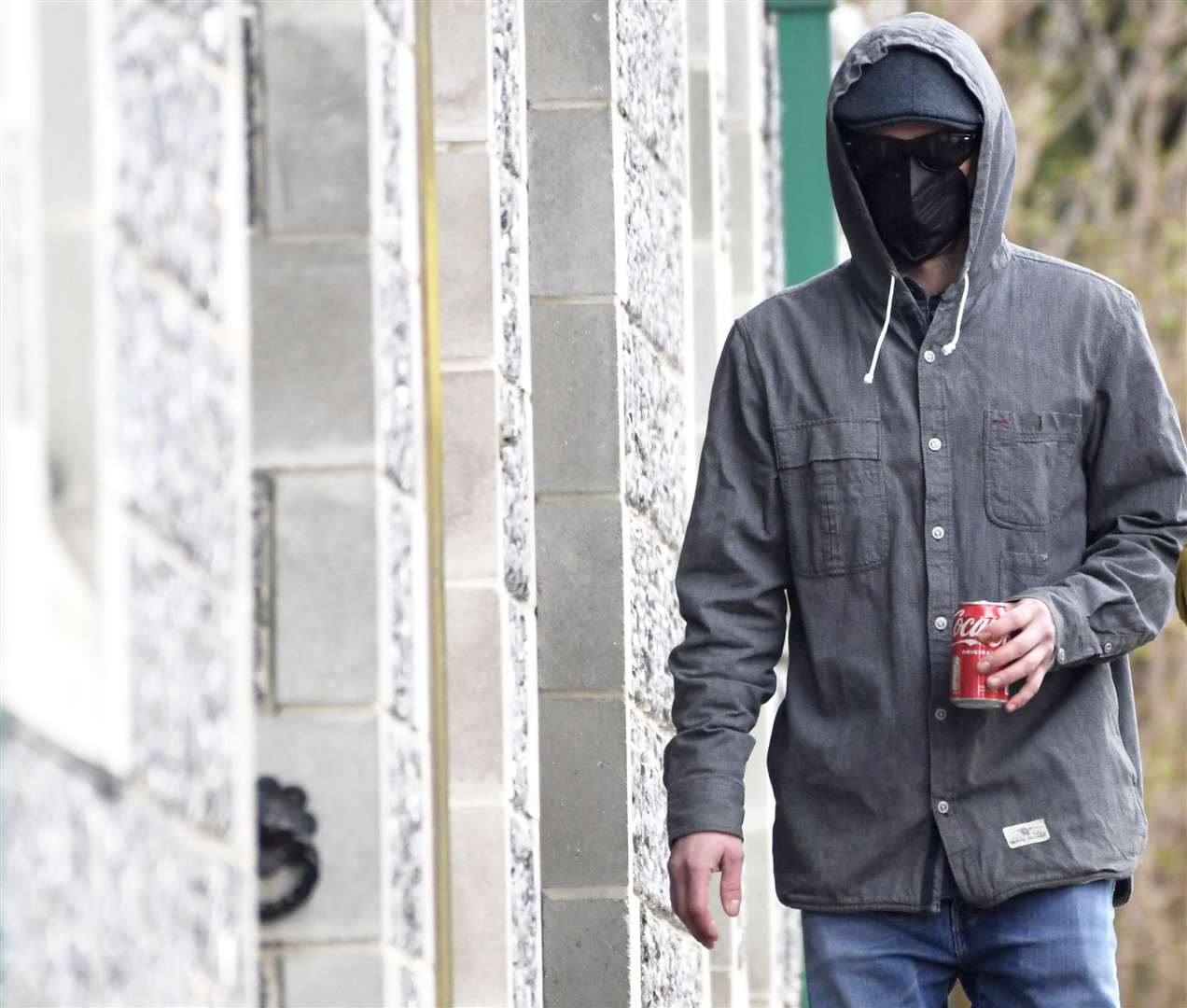 Phillip Henry wearing a face mask, sunglasses, a flat cap and with his hood up arriving at Canterbury Crown Court today. Picture: Barry Goodwin