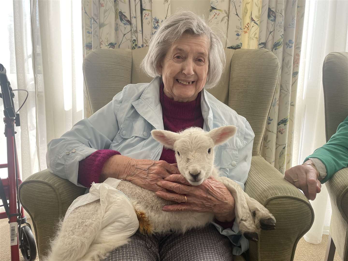 Shelia cuddling a lamb at the Whitstable care home. Picture: Harrier Lodge