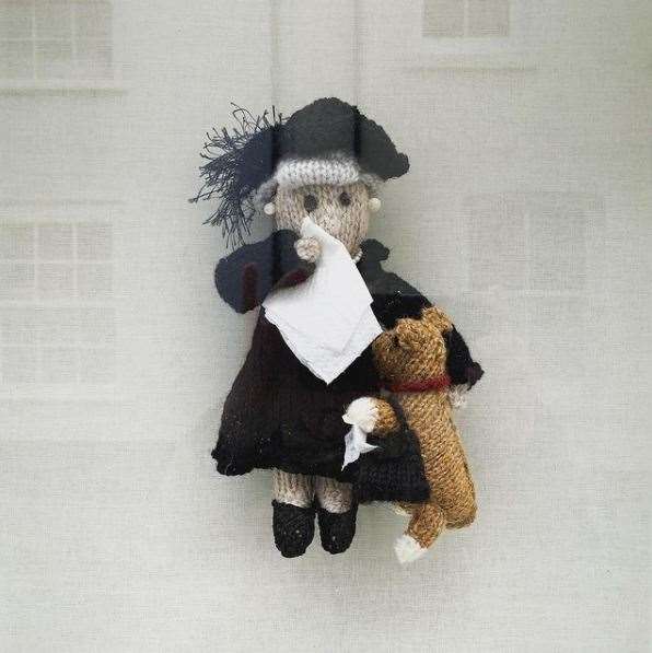 Pat Wilson has knitted a queen and corgi in mourning to add to the handcrafted creations she displays in her window