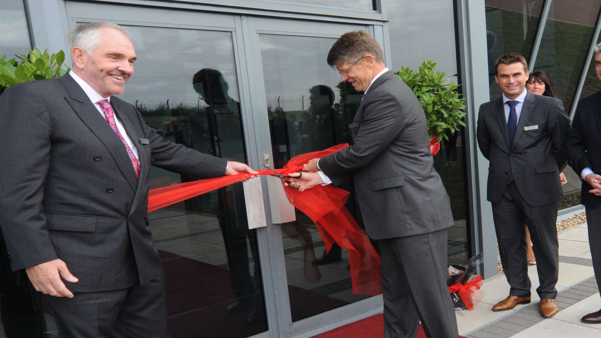 Ken Wills, far left, pictured at a ribbon-cutting ceremony at Heli Charter when the firm opened the UK's first purpose-built helicopter showroom and maintenance facility.