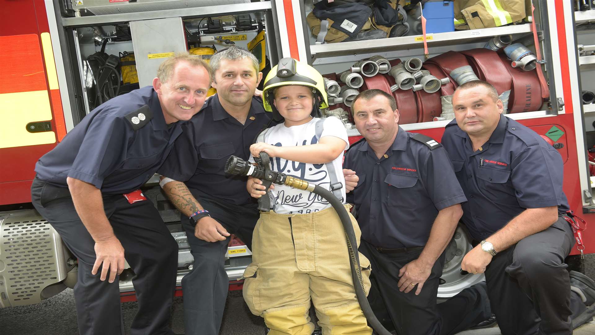 Aylesham celebrates ninety years. Nine year-old Jake Walford, spends time with the village firefighters