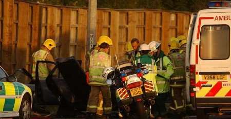 The emergency services working to free one of the drivers. Picture: JIM RANTELL