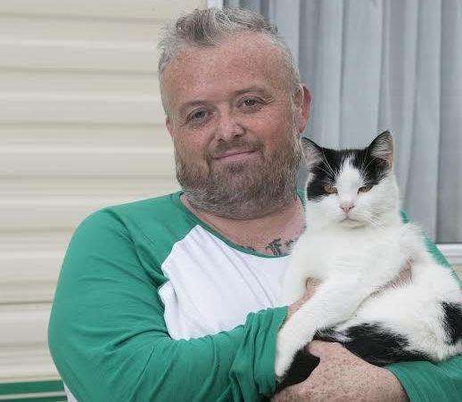Robin Barry with Frank the cat. Picture: Tim Stubbings/Caters News