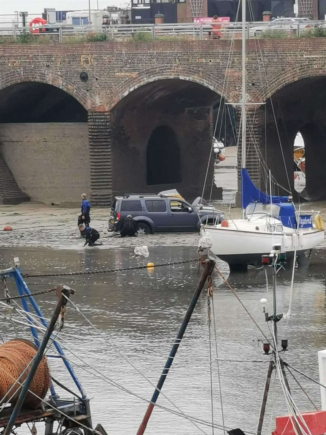 The Nissan was stuck in the mud before being claimed by the tide