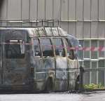 The burnt-out mini bus in the school grounds. Picture: JOHN WESTHROP