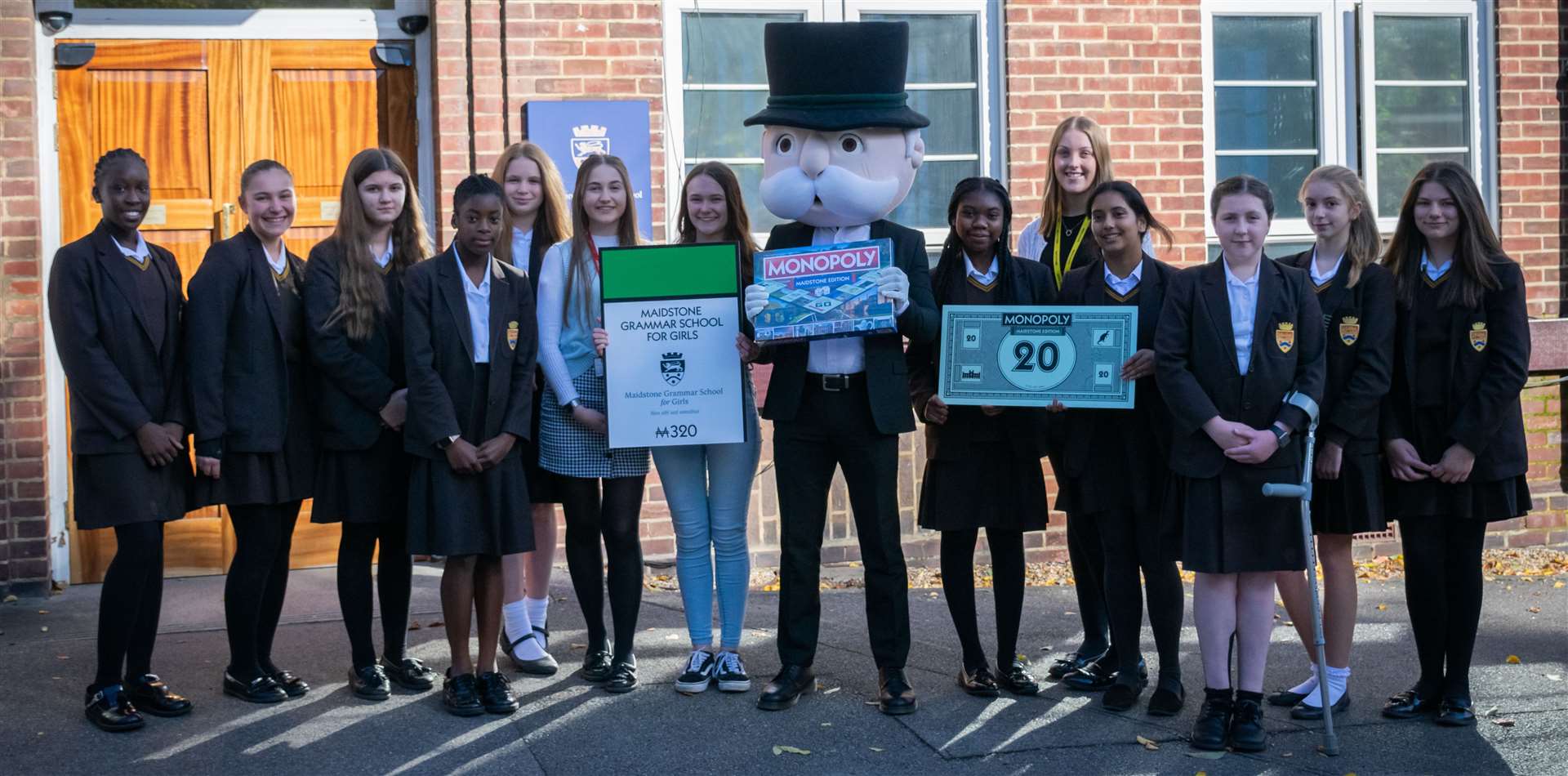 Pupils at Maidstone Grammar School for Girls celebrated with Mr Monopoly himself. Picture: MGGS