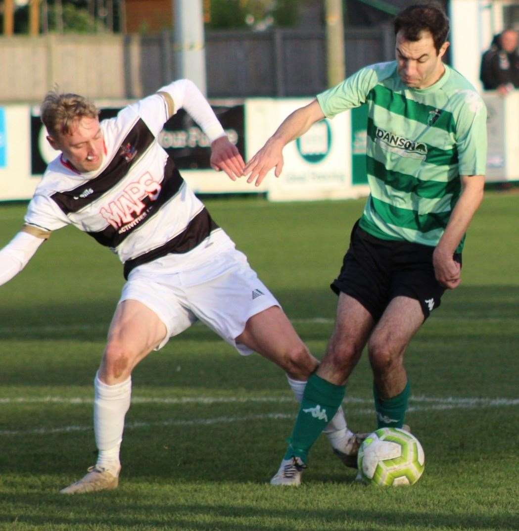 Deal Town's Ben Chapman challenges a Welling Town man. Picture: Bookatie Thompson