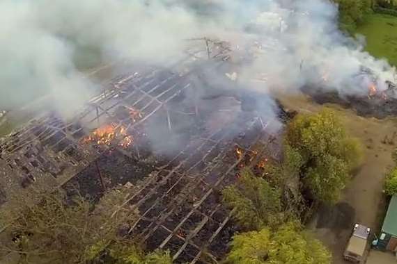 A barn's fire-ravage roof reveals damage caused by the blaze. Picture: Colin Spice/Kent Fire and Rescue Service