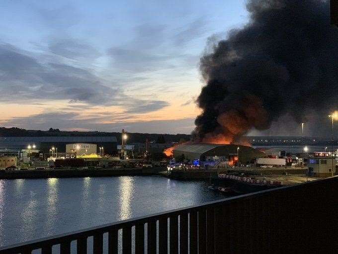 Plumes of black smoke from the Chatham Docks warehouse fire fill the sky at sunrise. Picture: @shaunhills