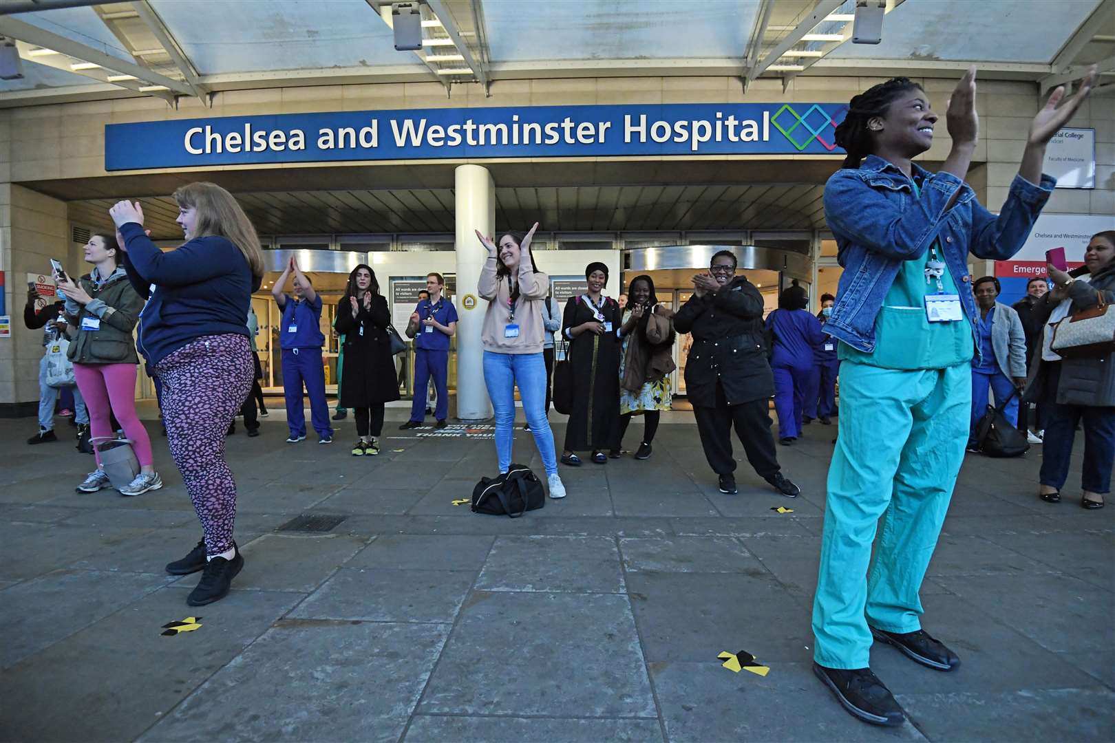 Medics outside the Chelsea and Westminster Hospital in London join in the applause (Kirsty O’Connor/PA)